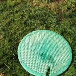 This is a common problem. Lid on the septic tank was damaged by a lawn mower. This damage destroys the lids structural integrity and allows Oder's to escape.